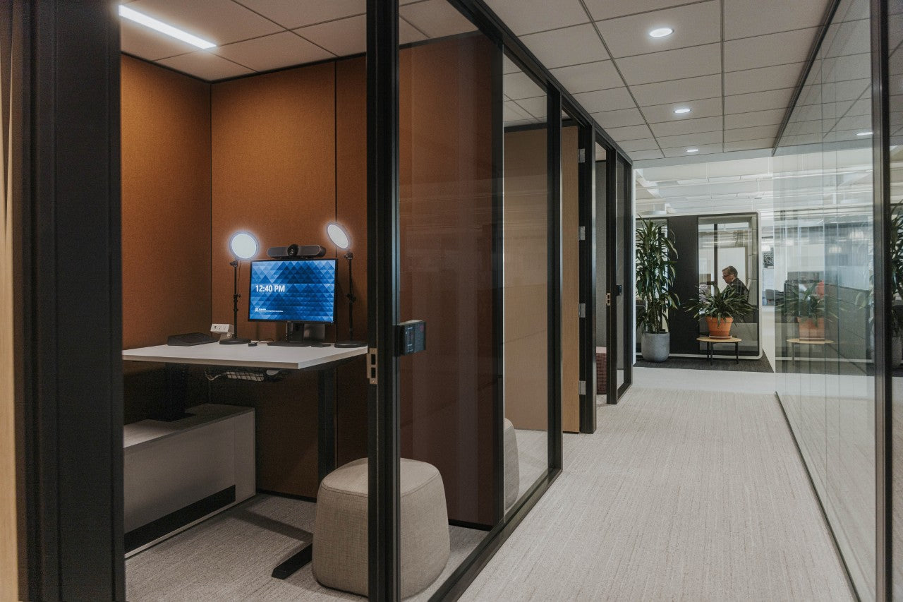 Modern office interior with a private office and open-plan area.