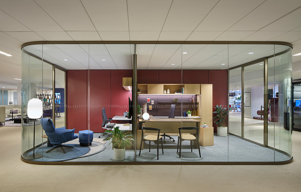 Modern office space with glass partition walls and office furniture.