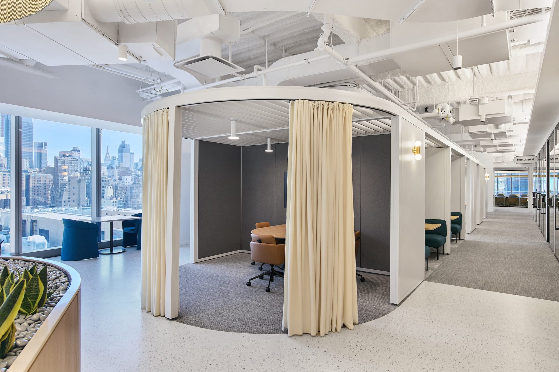 Modern office space with circular room divider and city view