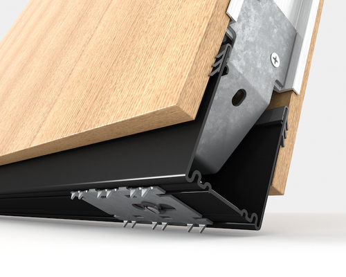 Close-up of a black threshold ramp attached to a wooden floor.