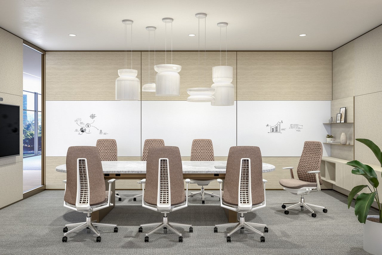 Modern conference room with a round table and chairs.