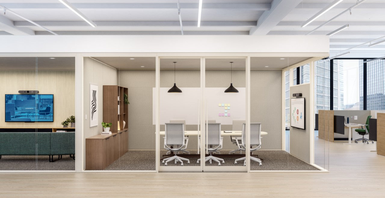 Modern office interior with glass partitions, desks, and chairs.