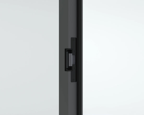 Close-up of a black door handle on a white door