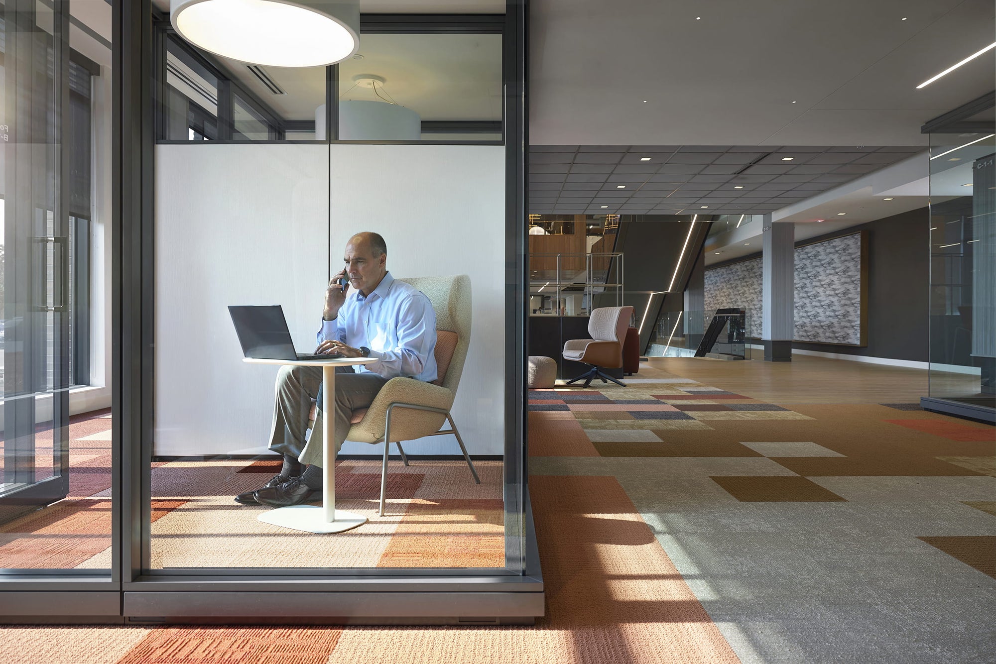 Person working on a laptop in a modern office setting