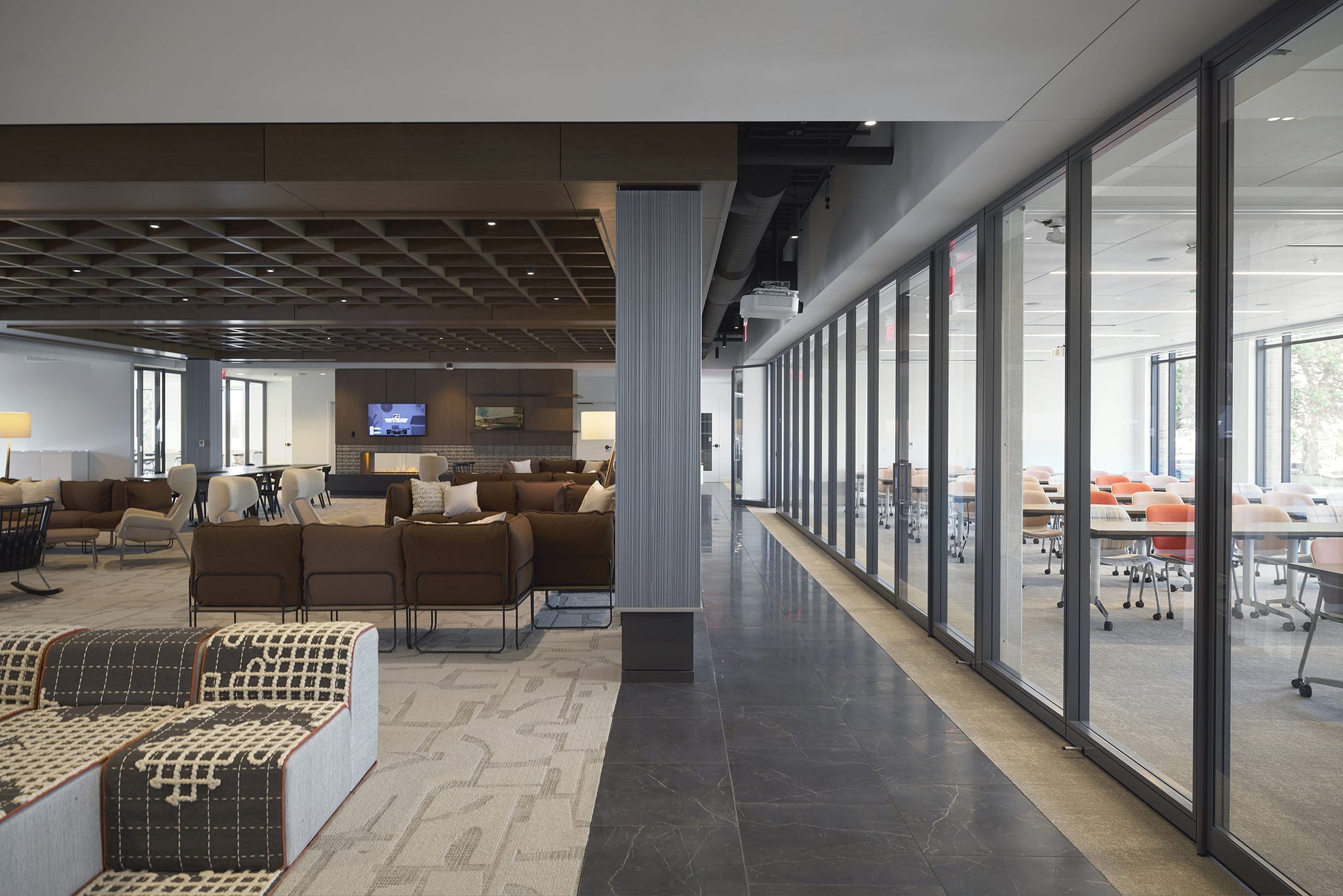 Modern office interior with lounge area and conference rooms.