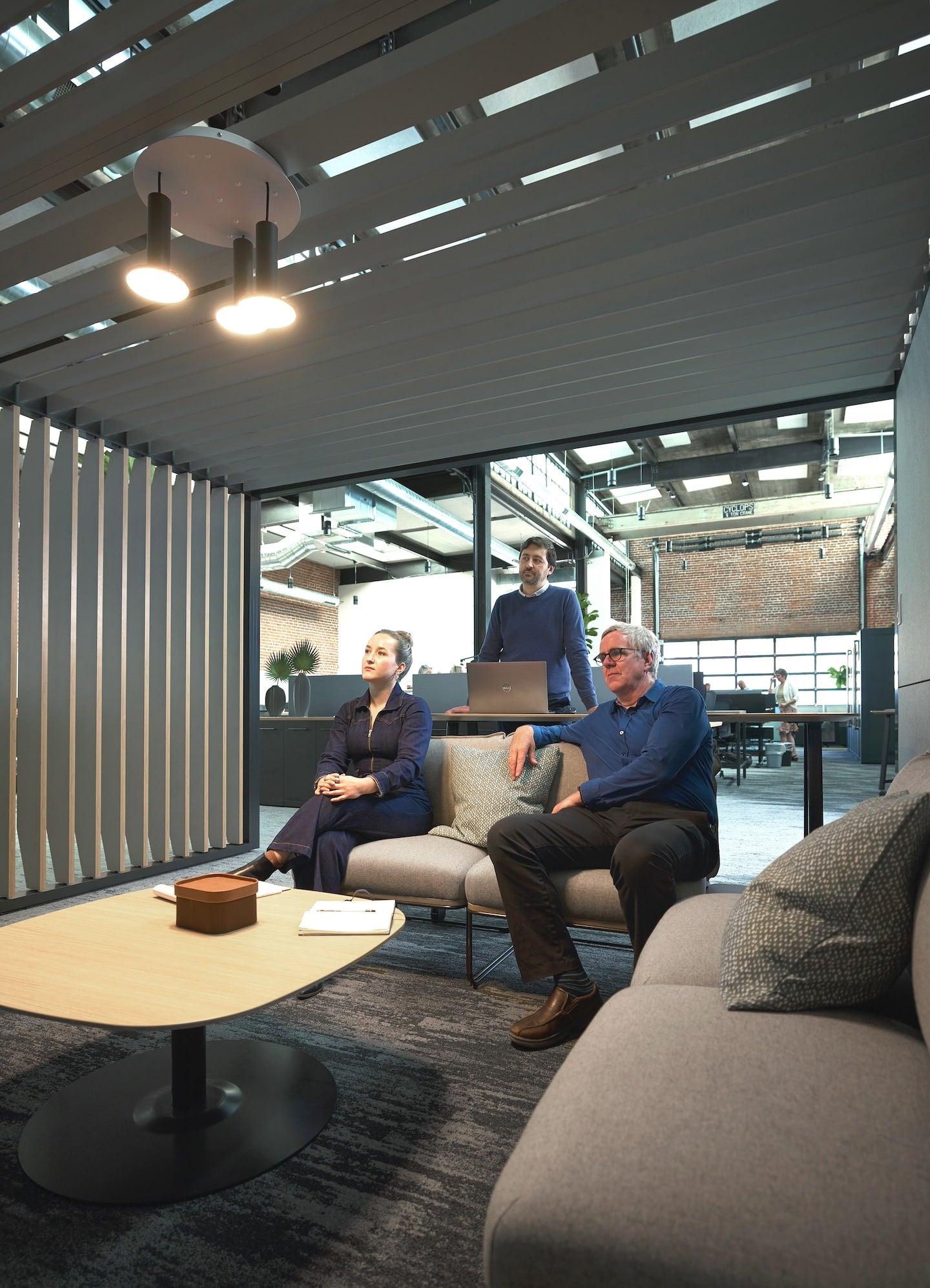 People sitting in a modern office space with large windows