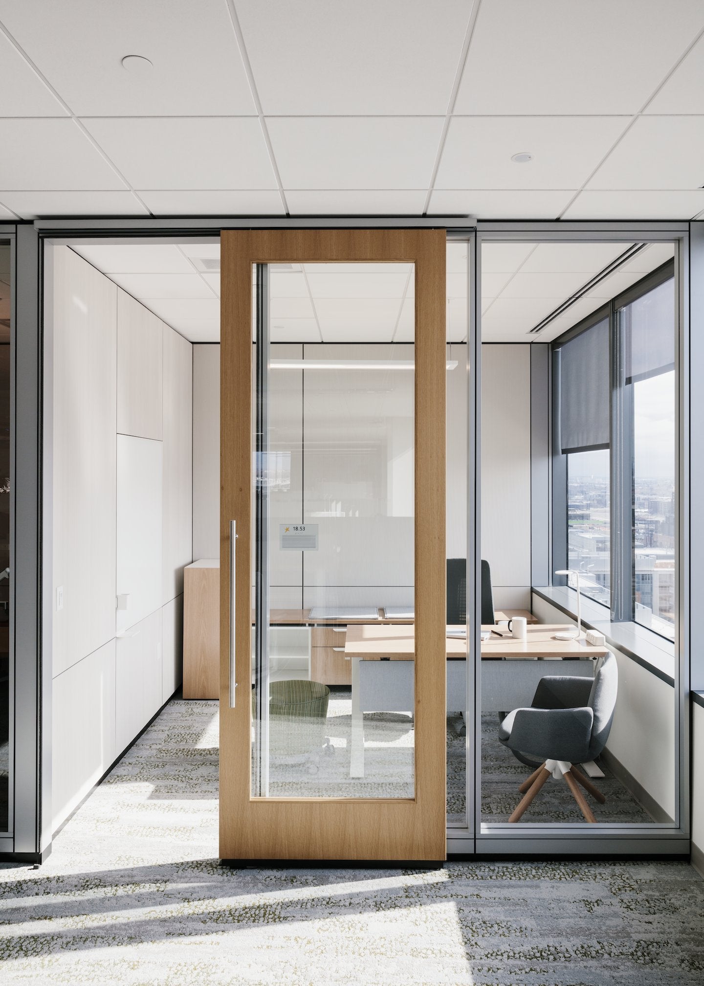 Modern office interior with glass door and office furniture