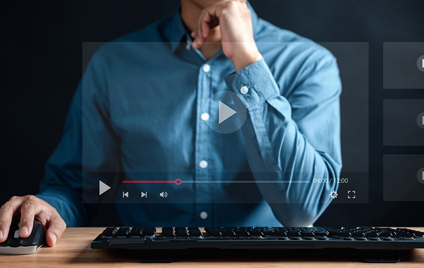 Person using a computer with a video player interface overlay