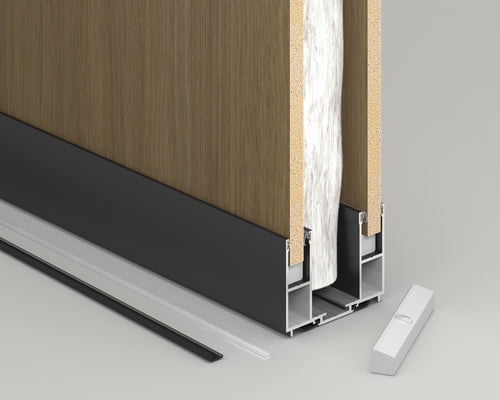 Close-up of a door frame with wooden paneling and metal trim on a gray background