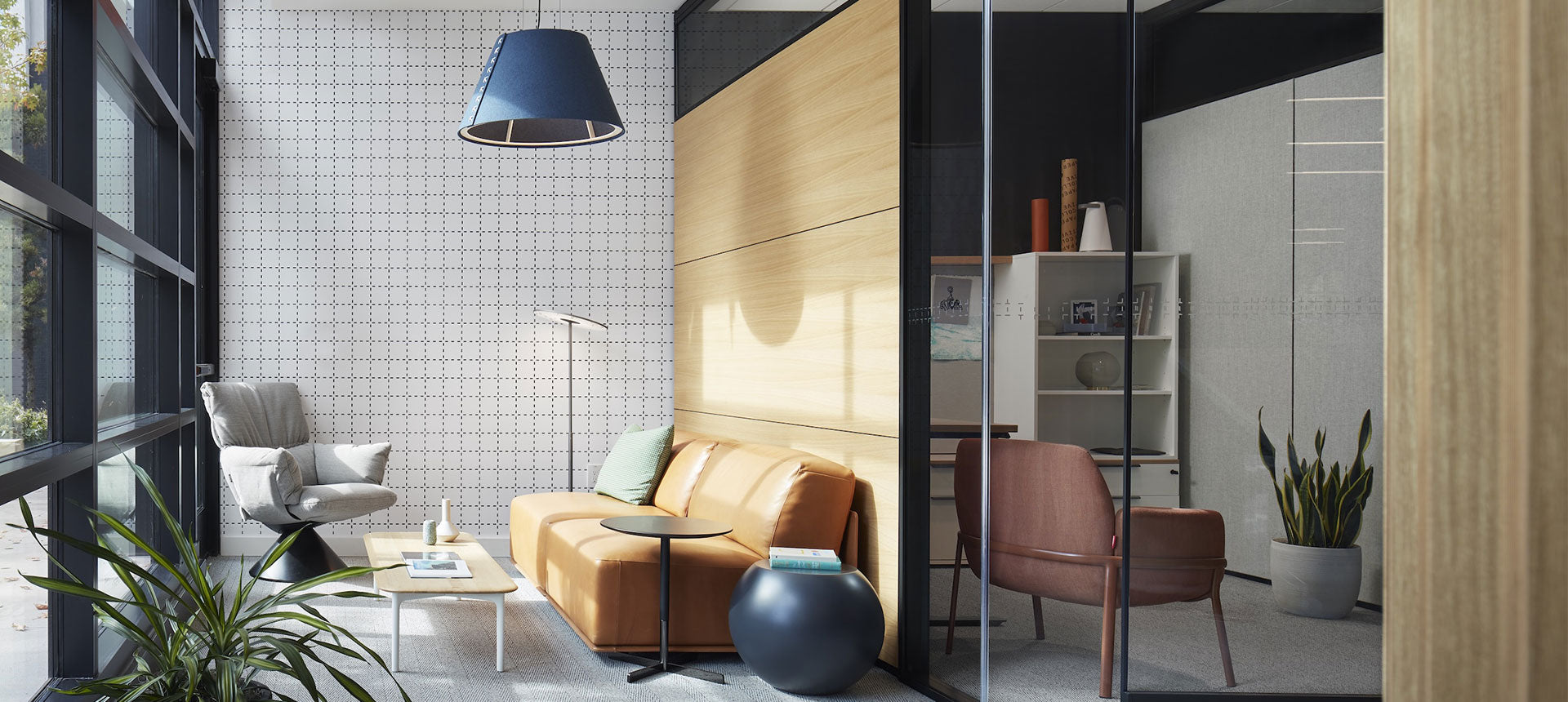 Modern living room with a sofa, chairs, and decorative items.