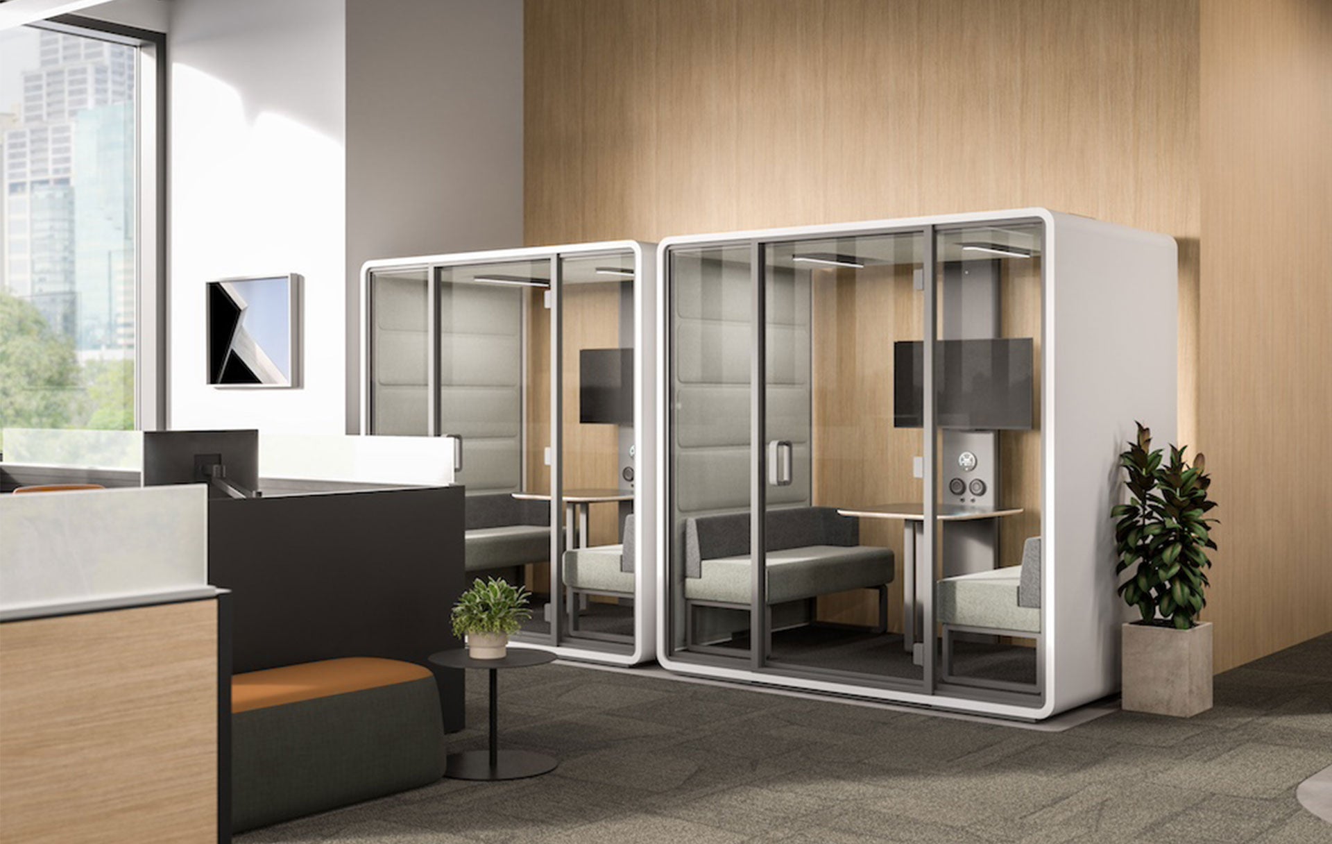 Modern office cubicles with glass walls in a well-lit room.
