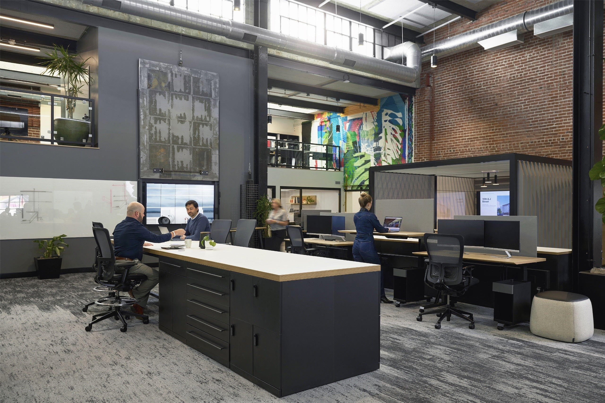 Modern office space with desks, chairs, and a casual atmosphere.