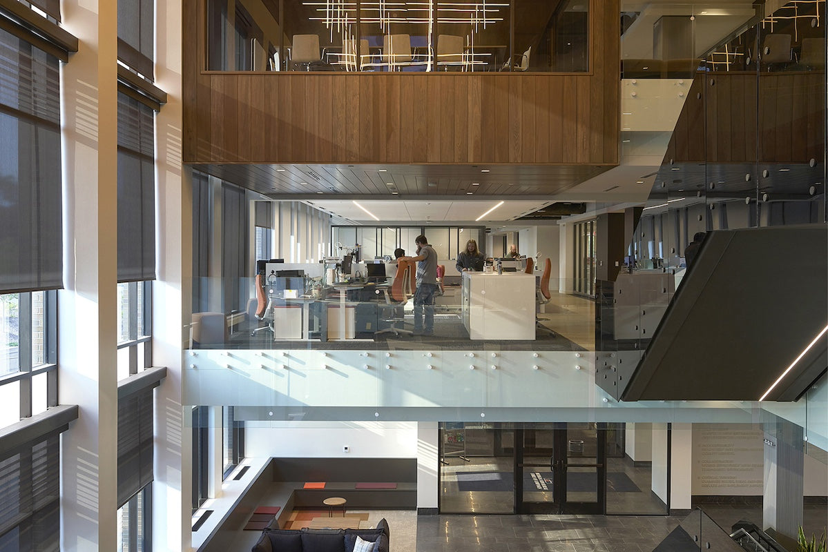 Modern office interior with glass walls and wooden accents
