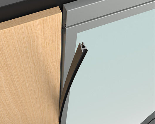 Close-up of a wooden cabinet door with a metal handle and glass panel.